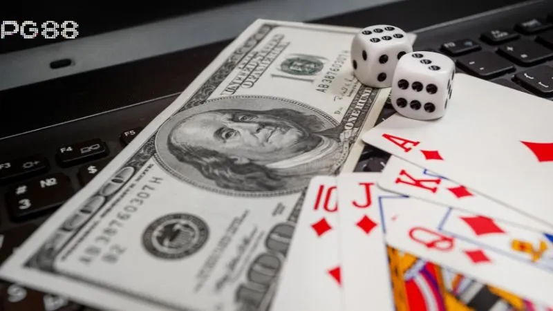 PG88 casino: lá bài tây, xúc xắc và tiền giấy trên bàn chơi.